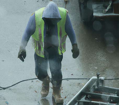 Wet worker being drenched on-site